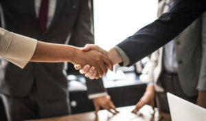 business people shaking hands in meeting room