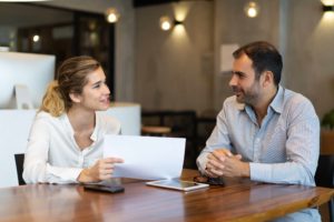 positive young employee showing report business colleague copia