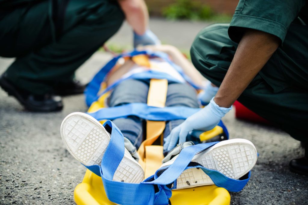 paramedic team rescuing young critical patient